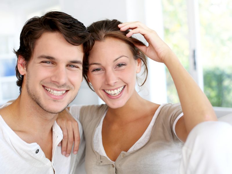 Portrait of smiling young couple at home